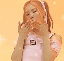 a girl with pigtails is wearing a white shirt and a white ribbon around her neck .