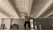 a person wearing a mask is dancing in a dance studio ..