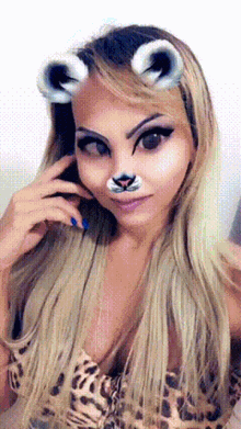 a woman in a leopard print top has a fake nose and ears on her face