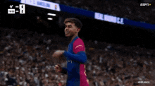 a soccer player celebrates a goal during a match with espn