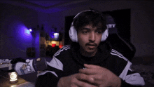 a man wearing headphones with the letter t on his back