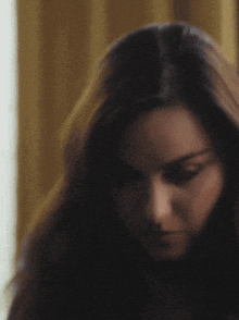 a close up of a woman 's face with long hair