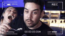 a man and a woman are being recorded and the time is 00 00 05 09