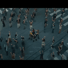 a group of people are dancing in a circle and one of them is wearing a shirt that says nkr on it
