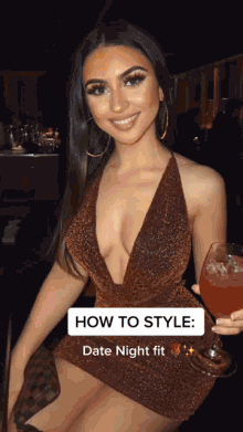 a woman in a halter dress is holding a glass of wine and smiling