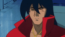 a man wearing a red jacket and a gold necklace with a cross on it