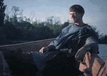 a man in chain mail sits in a boat with the words lord-archer.com gifs below him