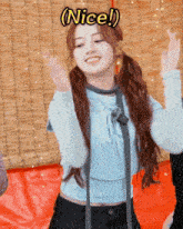 a girl in a blue shirt is dancing with the words nice written above her