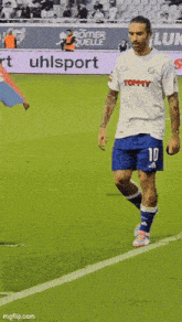 a soccer player wearing a white shirt with the number 10 on it