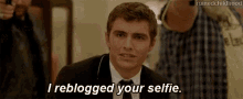 a man in a suit and tie is saying i reblogged your selfie .