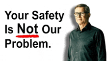 a man in a black shirt stands in front of a sign that says your safety is not our problem