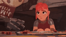 a girl with red hair is sitting at a table with a pizza box in the background that says jino pizza