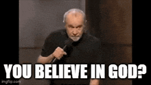 a man is holding a microphone in his hand and says `` you believe in god ? ''