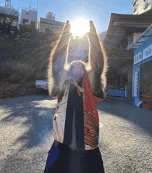 a monkey is holding up the sun in front of a building that says ab