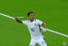 a soccer player wearing a white shirt with a md logo on it is celebrating a goal on the field .