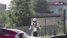 a person riding a motorcycle with the word kamen rider on the bottom