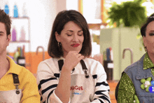 a woman wearing an apron that says nigge on it is thinking
