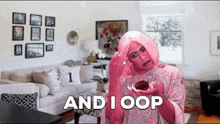 a woman in a pink wig is holding a cupcake and says " and i oop "