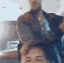 a man is holding a woman 's head in a blurry picture .