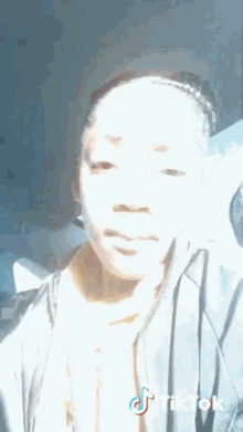 a woman is taking a selfie with a tiktok logo on her face