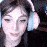 a close up of a woman wearing headphones and smiling