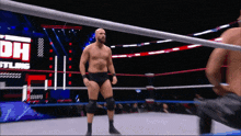 a man in a wrestling ring with the word dh on the screen