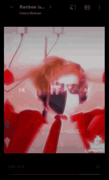 a person wearing a mask and sunglasses is playing a video on a phone .