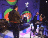 a band on stage with a marshall amplifier