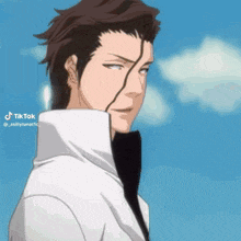 a close up of a man 's face with a blue sky in the background and a tiktok watermark