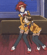 a girl with red hair is hugging another girl on a red floor