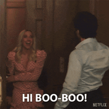 a man and a woman are standing next to each other and the woman is saying hi boo-boo
