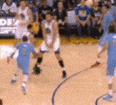 a group of basketball players on a court with the number 3 on the back of their jersey