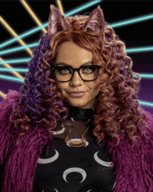 a woman with curly hair and glasses is wearing a cat costume
