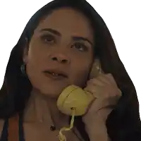 a woman is talking on a yellow telephone with a necklace around her neck