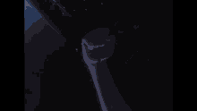 a man in an apron is standing in a dark room holding a sword in his hand .