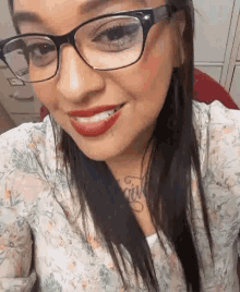 a close up of a woman wearing glasses and red lipstick