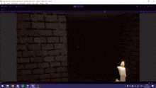 a computer screen shows a candle and a brick wall in the background