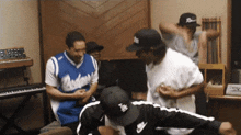 a man in a dodgers jersey is dancing in a room