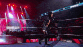 a wrestler is walking out of a wrestling ring that says top city on the side