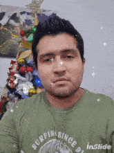 a man wearing a green shirt that says surfing since 9 on it