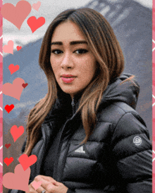 a woman wearing a black jacket with the word adidas on the sleeve
