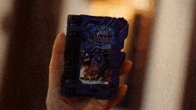 a person is holding a purple book that says shake dragon on it