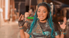 a woman with blue hair is wearing a leopard print jacket