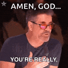a man wearing glasses and a black shirt is saying amen god you 're really