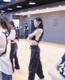 a group of girls are dancing in a dance studio
