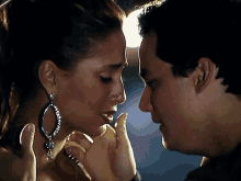 a man and a woman are looking at each other