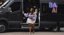 a woman getting out of a van that says zeus on the side