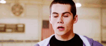 a close up of a young man making a funny face .