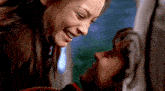 a man and a woman are looking into each others eyes and smiling
