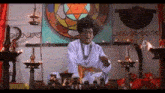 a man with an afro is standing in front of a stained glass window